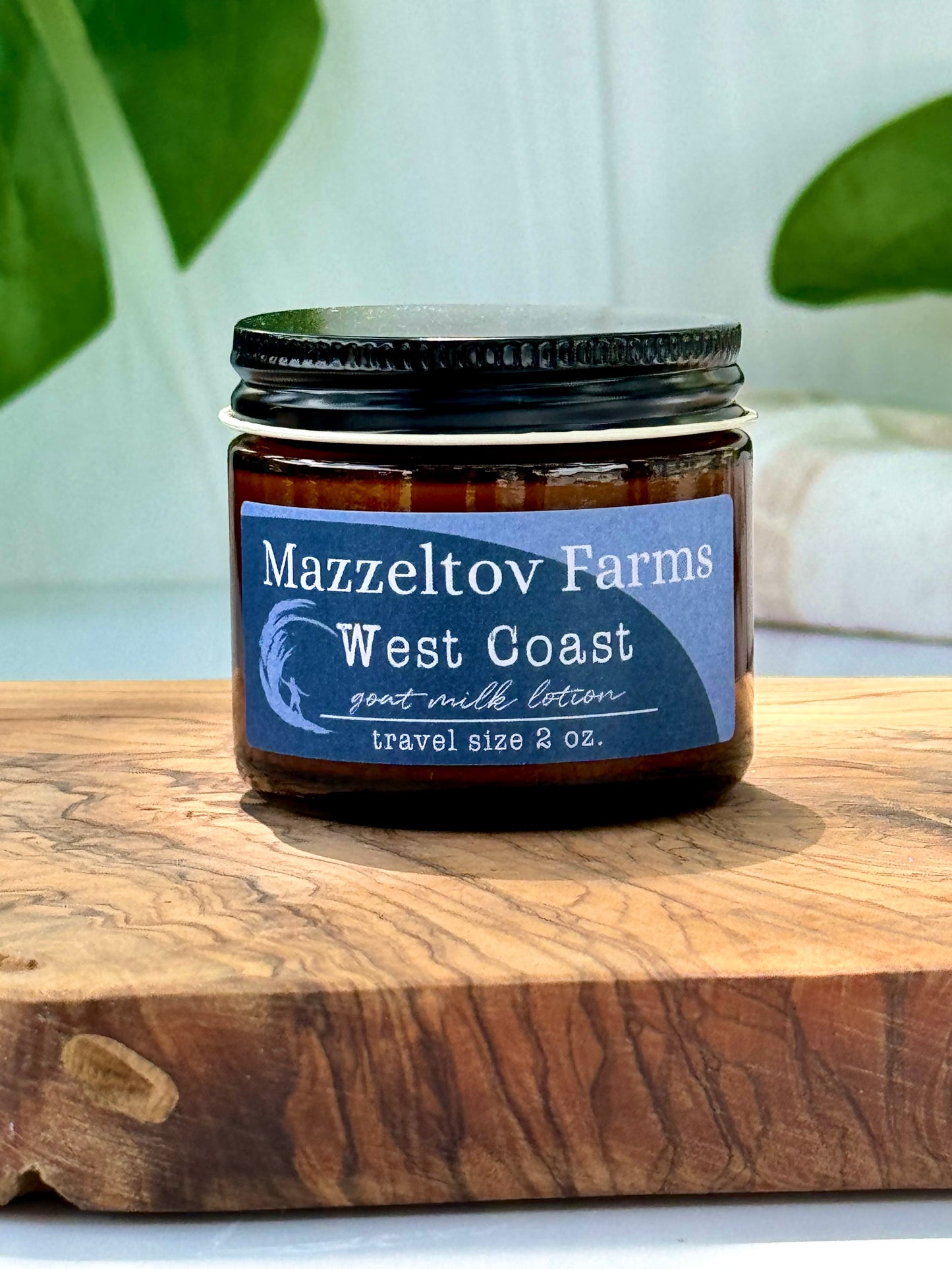 West Coast goat milk lotion in small amber glass jar with twist cap, oceanic scented natural lotion