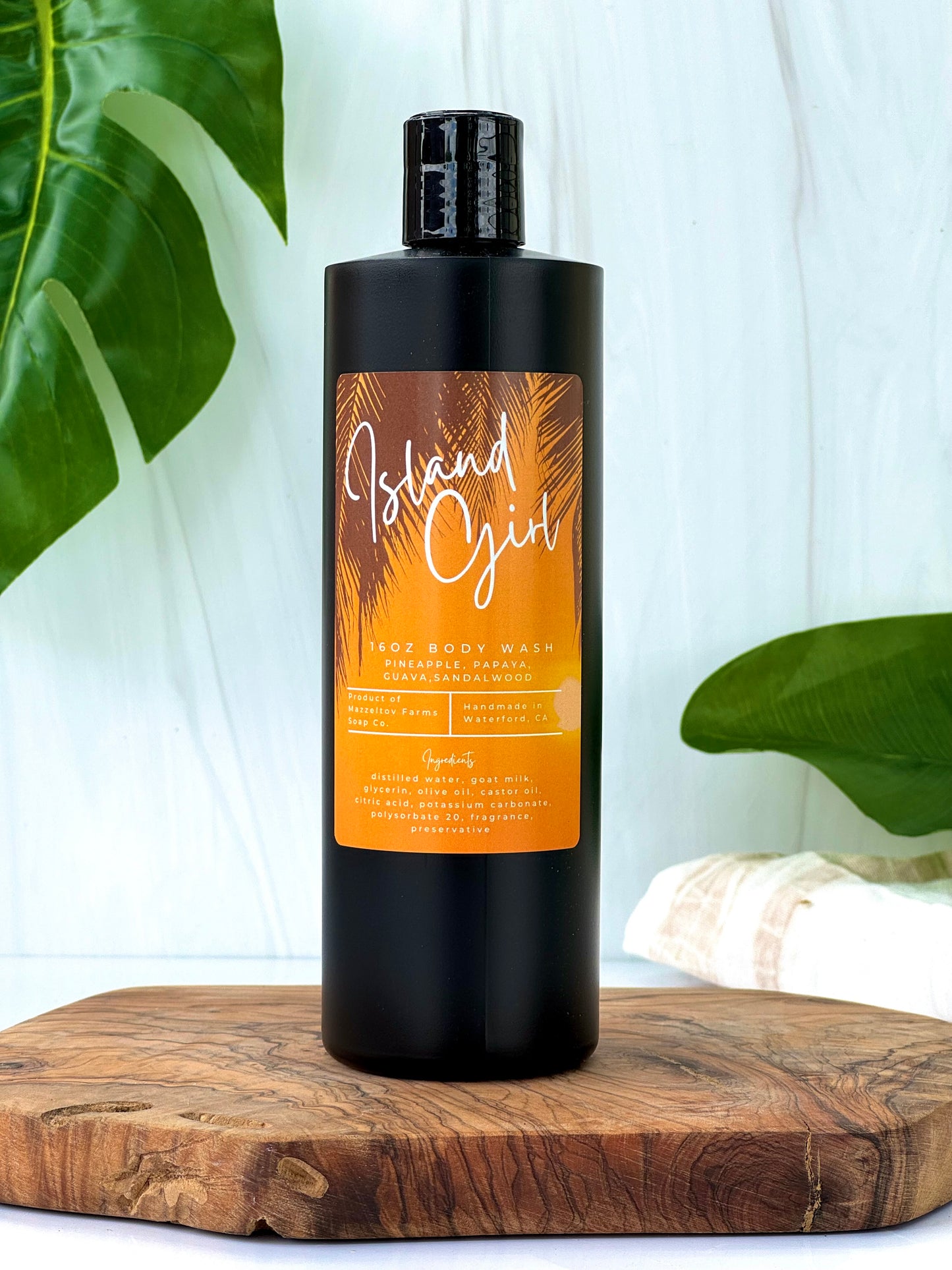 Island Girl goat milk body wash in black squeeze bottle, tropical fruity scented natural body wash