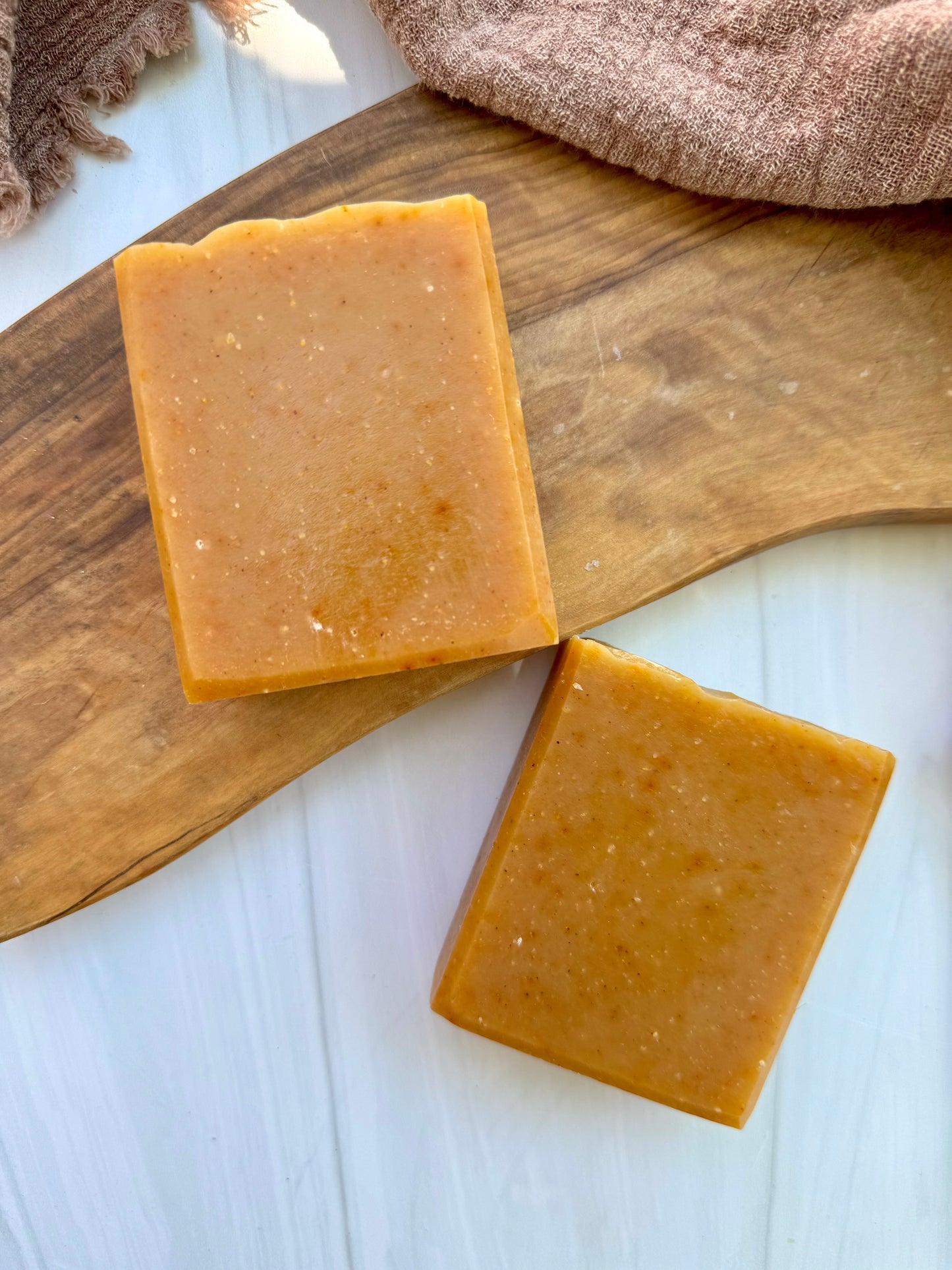 Patchouli Sunrise goat milk soap bar handmade by Mazzeltov Farms Soap Co. Warm orange bar naturally colored with annatto seed powder, scented with orange and patchouli essential oils.