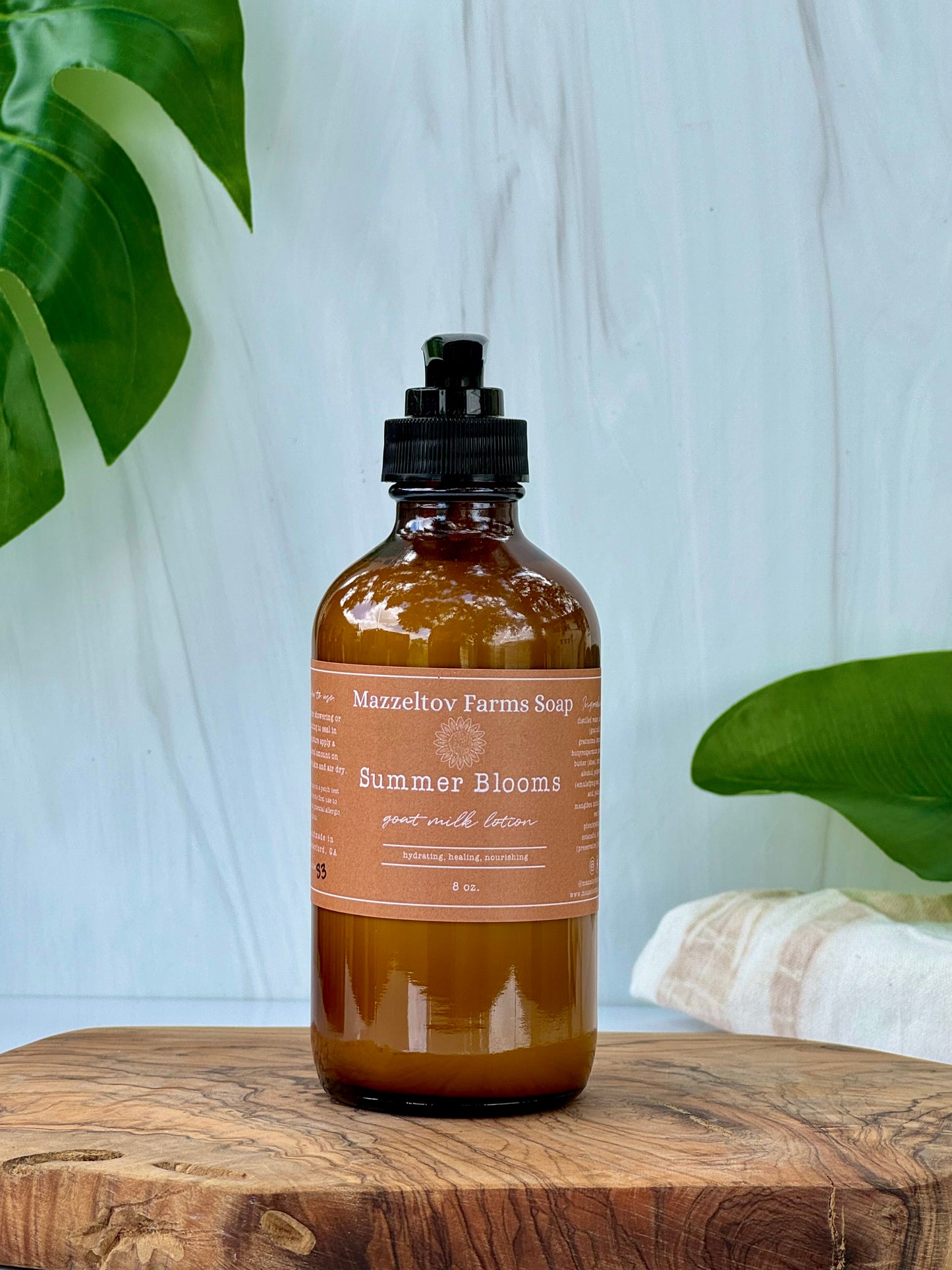 Summer Blooms goat milk lotion in 8 oz amber glass bottle with pump, fruity floral scented natural body lotion