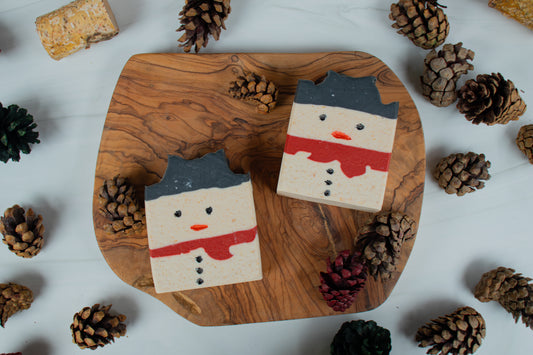 Frosty the Soapman limited edition handmade goat milk soap bar from Mazzeltov Farms Soap Co. Charcoal, cream, and red layered design with a fresh winter forest scent.
