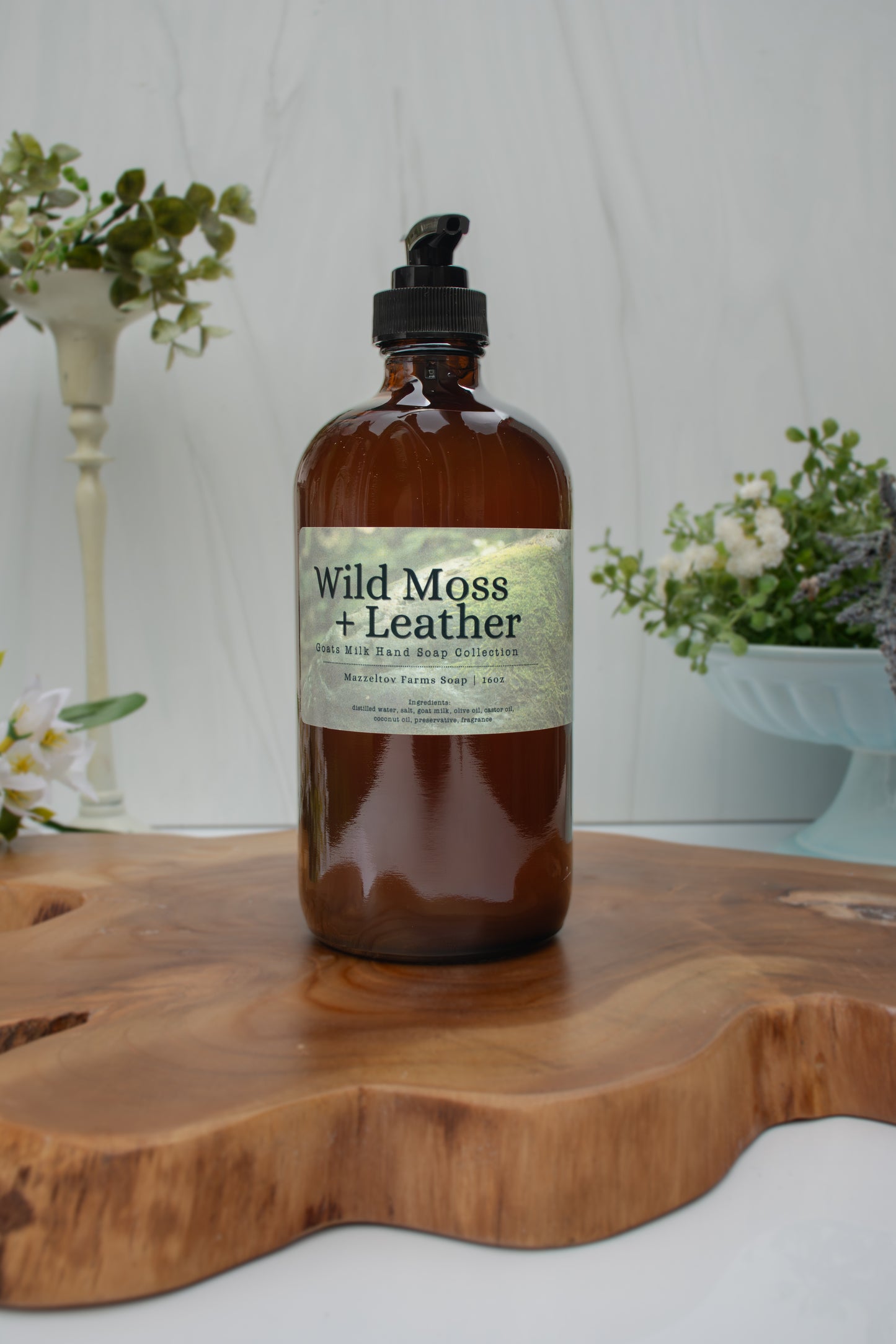 Wild Moss + Leather goat milk liquid hand soap by Mazzeltov Farms Soap Co. 16 oz amber glass bottle with pump and a rich earthy scent of amber, leather, oakmoss, sage, and lavender.