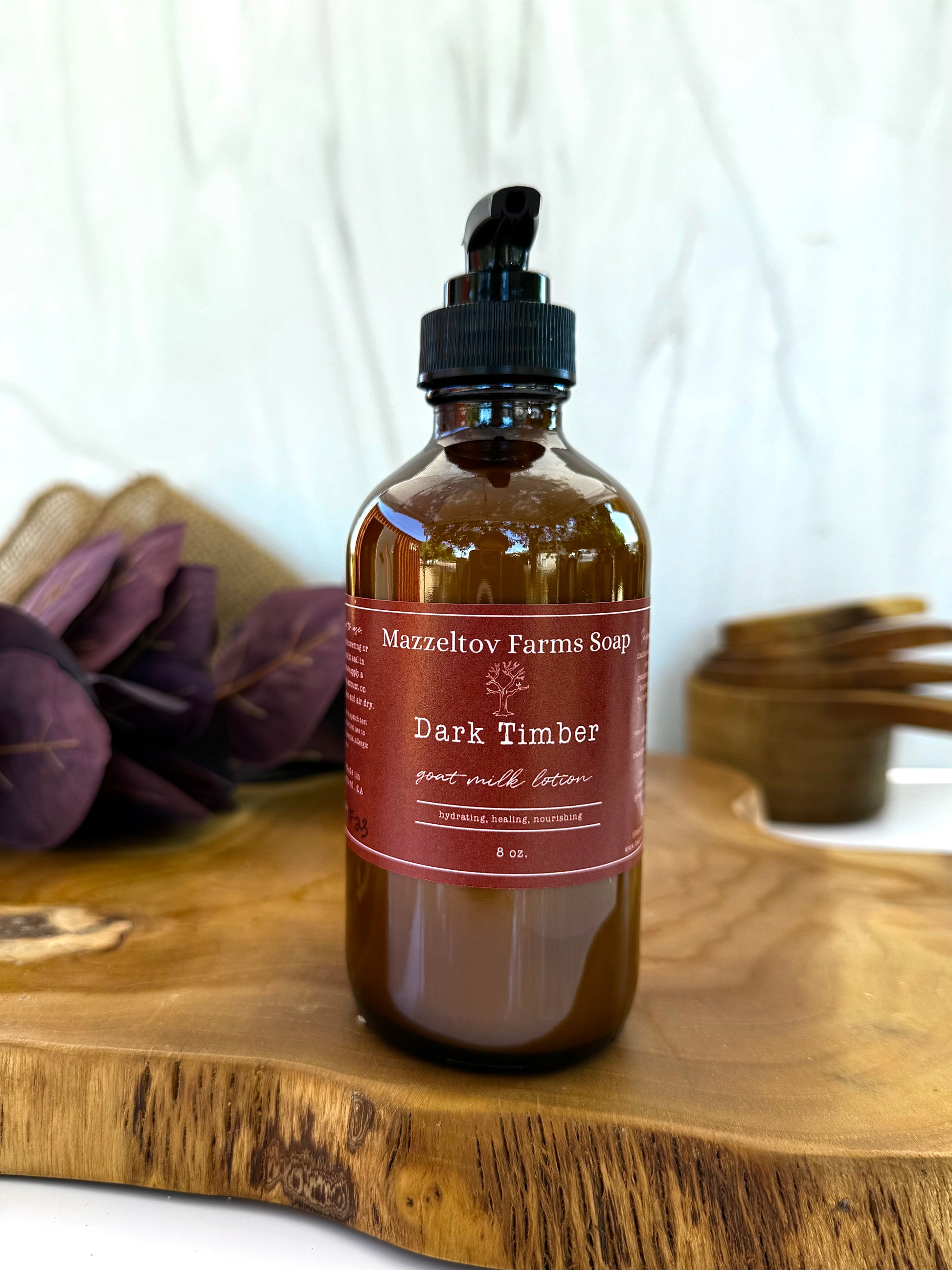 Dark Timber goat milk lotion in 8oz amber glass pump bottle