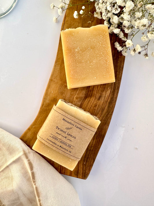 Twisted Lemon goat milk soap bar handmade by Mazzeltov Farms Soap Co. Yellow and cream bar with lavender buds, naturally colored with turmeric and scented with lemon, lavender, and peppermint essential oils.