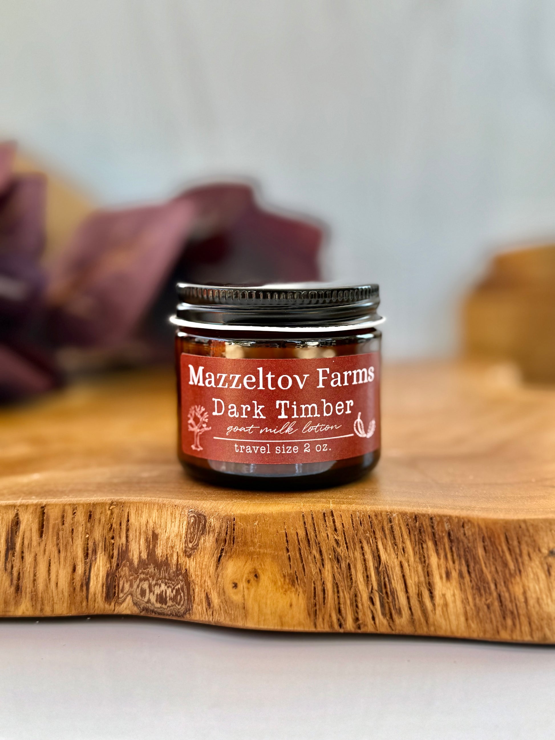 Dark Timber goat milk lotion in 2oz amber glass jar