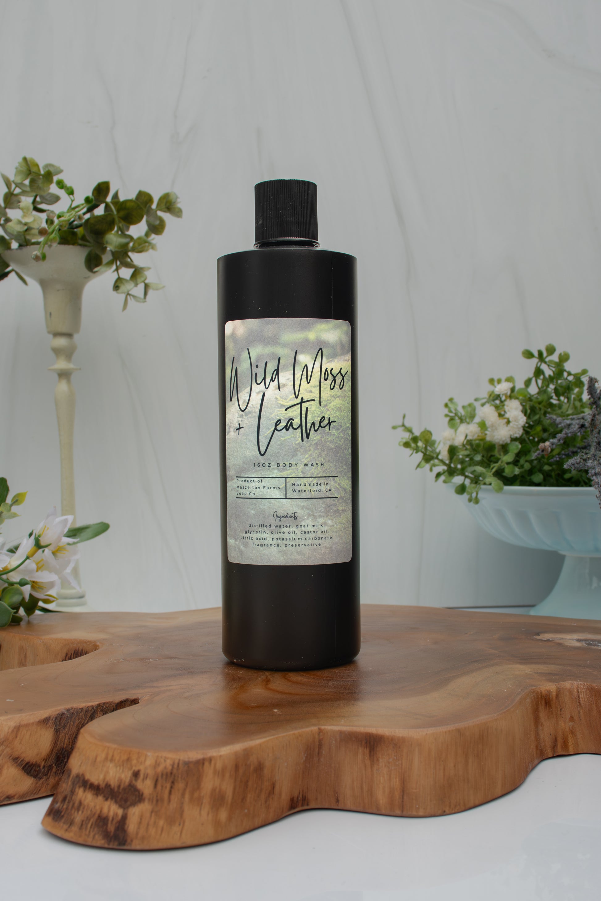 Wild Moss + Leather goat milk body wash by Mazzeltov Farms Soap Co. 16 oz black squeeze bottle with a rich earthy scent of amber, leather, oakmoss, sage, and lavender.