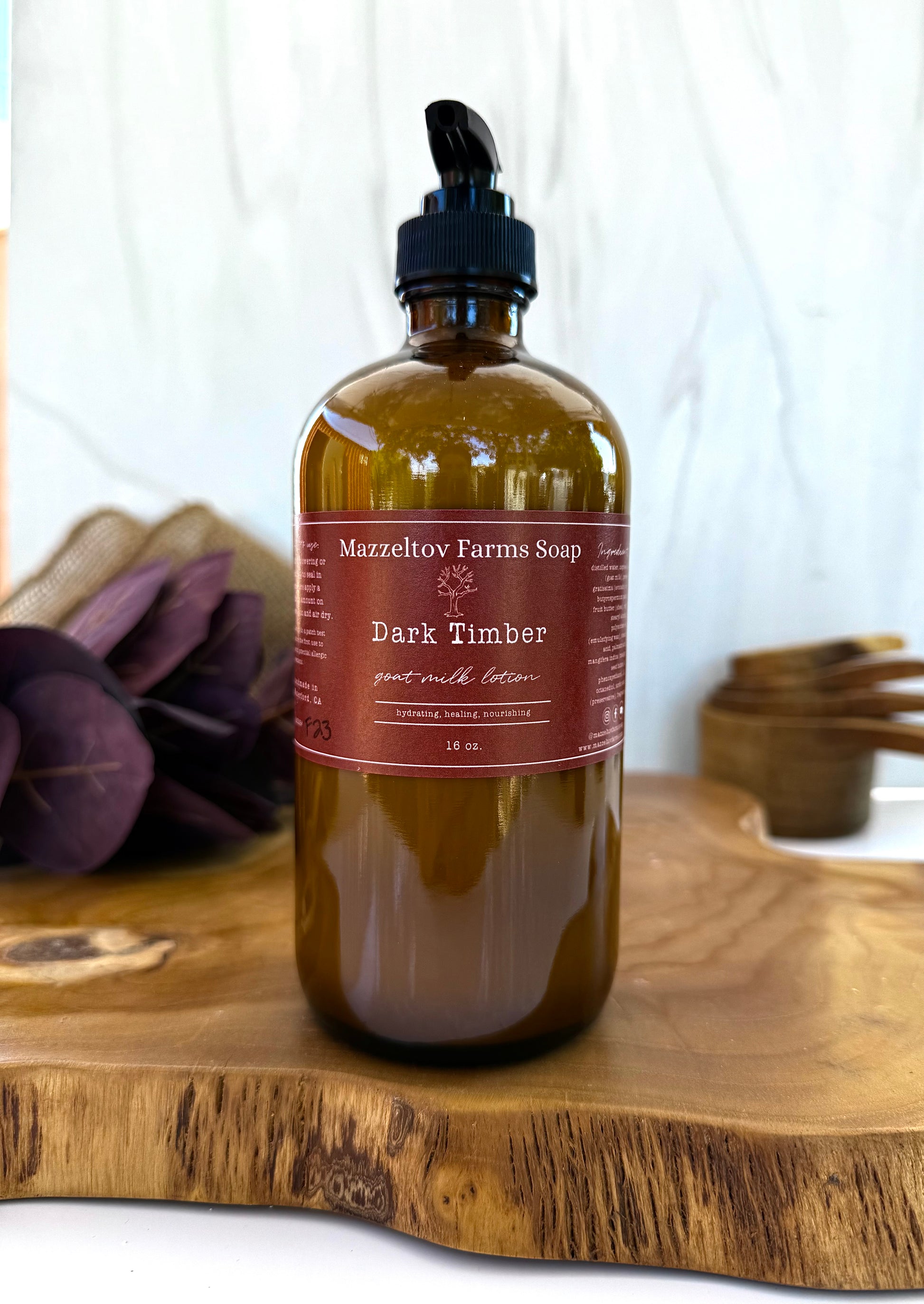 Dark Timber goat milk lotion in 16oz amber glass pump bottle