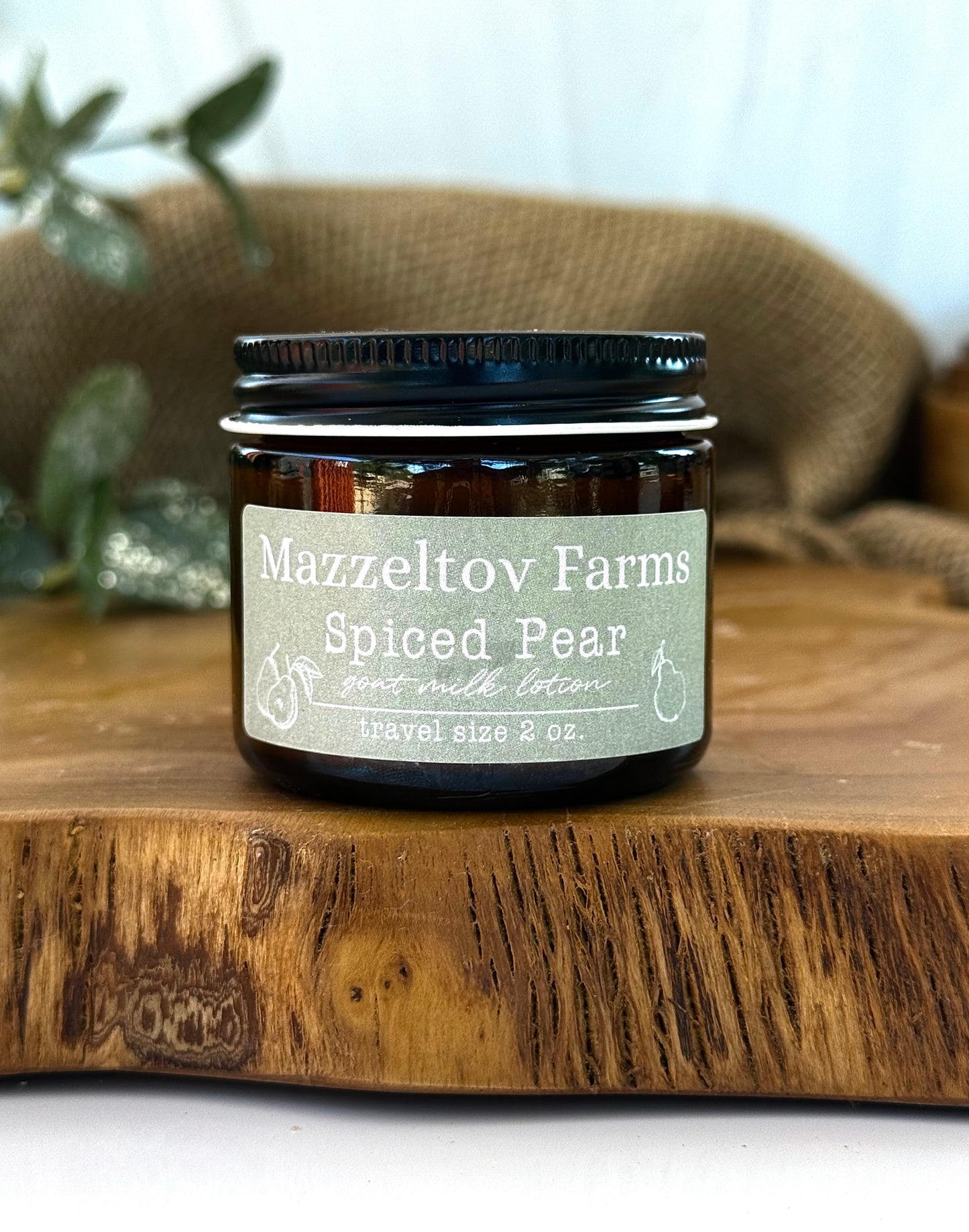 Spiced Pear goat milk lotion in 2oz amber glass jar